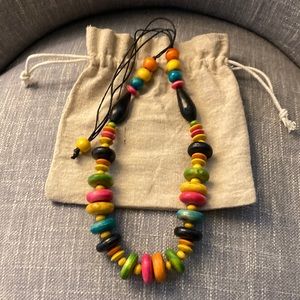 It’s wood necklace hand made, multi-colored with black stripes easy to adjust.